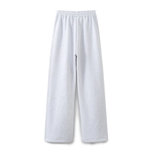 Detail of light gray knitted wide-leg sweatpants with elastic waistband on white background