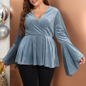 Detail of light blue V-neck top with metallic ripple fabric and flared long sleeves