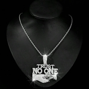 Hip hop necklace with iced out Trust No One pendant and handshake motif on black bust