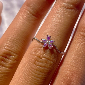 Elegant floral silver ring featuring sparkling aurora crystals on a textured beaded band