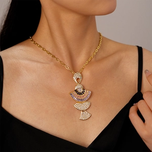 Detail of fan-shaped pendant necklace with colorful zircons worn by a model