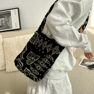 Detail of soft black and white geometric plush fabric on the stylish crossbody bucket bag