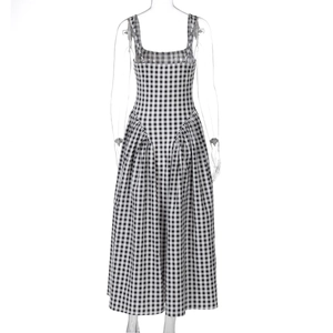 Front view of black and white plaid sundress with a high waist and pleated ankle-length hem