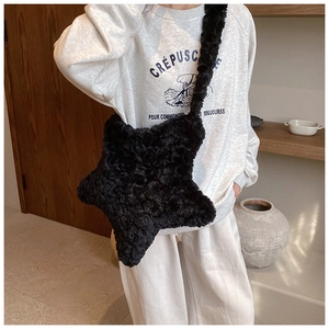 Detail showing the plush black star-shaped crossbody bag with soft faux fur texture