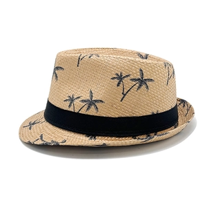 Detailed macro view of woven paper straw texture with palm tree print and black ribbon band