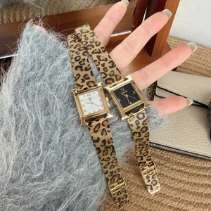 Detail view of gold-tone H-shaped quartz watch with leopard print metal mesh strap