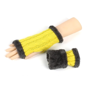 Detail of yellow cable knit fingerless glove with dark grey faux fur trim on the cuff