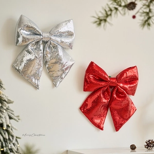 Sparkling red and silver Christmas bows with sequins for holiday window display decoration
