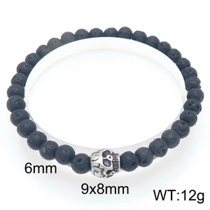 Detail view of 6mm black lava rock beads and a vintage silver skull charm on a bracelet