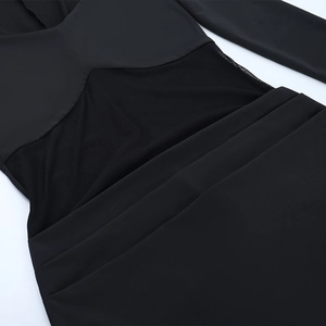 Detail view of mesh patchwork and horizontal ruched texture on the black elegant dress