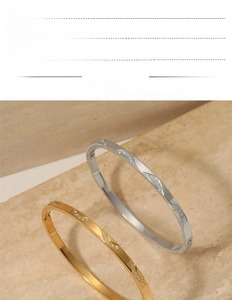 Close-up of wavy stainless steel zircon bracelet showing PVD gold and silver plating