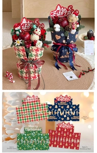 Christmas gift box wrap with festive patterns including gingerbread man and plaid motifs