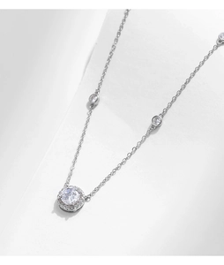 Close-up of S925 sterling silver halo pendant necklace with sparkling round diamonds
