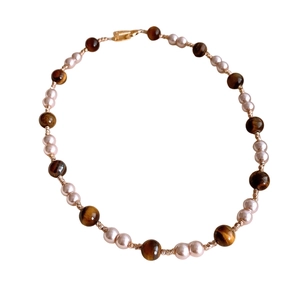 Tiger eye and pearl beaded necklace with gold lobster clasp on white background