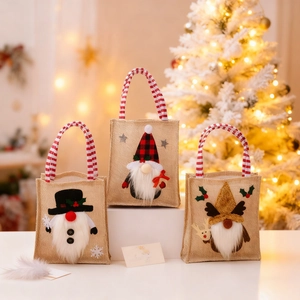 Three-piece set of Christmas burlap gift bags with cute gnome designs and striped handles