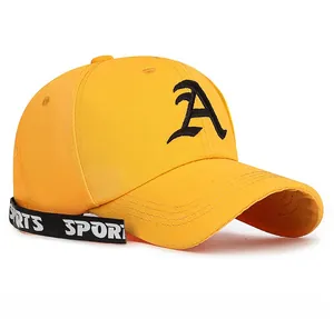 Detail of yellow baseball cap with black letter A embroidery and sports ribbon strap