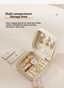 Internal view of white PU leather jewelry box showing ring slots and necklace hooks
