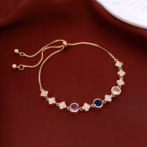 Macro detail of adjustable 18k gold flower bracelet with colorful gemstones and zircons