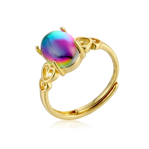 Adjustable gold ring with hollow heart design and iridescent oval stone on white background