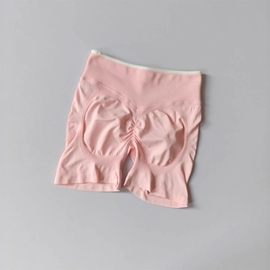 Close-up of pink seamless yoga shorts featuring a high waistband and scrunch butt detail