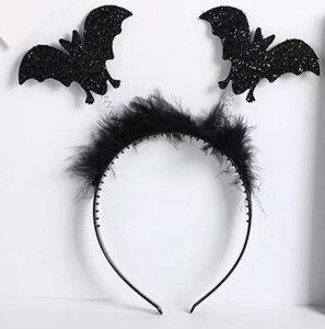 Detail of Halloween headband with black twin bats and delicate feather accents