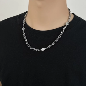 Silver titanium steel chain necklace with diamond geometric elements worn by a model