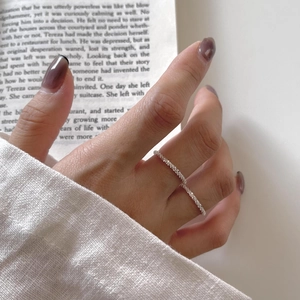 Detail of a minimalist S925 sterling silver ring with shimmering textured finish