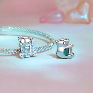 Cute 925 sterling silver bear charm with blue opal accents on a mesh chain bracelet