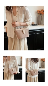 Detail of beige woven crossbody bag with gold ring buckle and leather strap on model