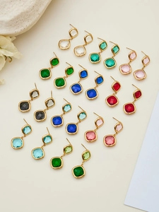 Detailed grid of geometric square glass stone earrings in various vibrant colors and gold metal