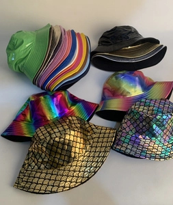 Close-up of metallic faux leather bucket hats featuring colorful iridescent scale textures