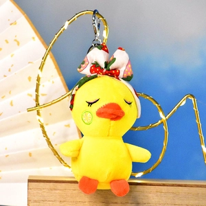 Cute yellow plush duck keychain accessory with a strawberry pattern bow detail