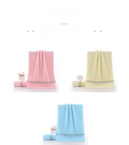 Three-color cotton towels in pink, yellow, and blue with stylish colored striped edges