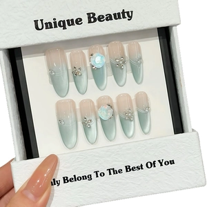 Blue cat-eye press-on nails with 3D floral and gem accents in elegant gift box