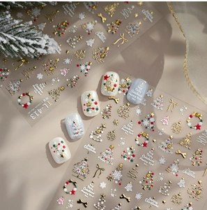 Detailed view of 3D gold embossed Christmas nail stickers with tree and wreath motifs
