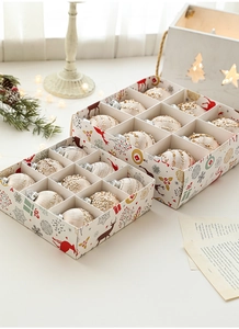 Close-up of champagne gold Christmas balls with glitter and bead details in festive boxes