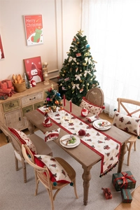 Detailed Christmas table runner and pillow set with festive reindeer and snowflake patterns