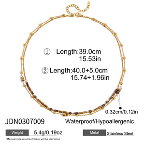 Detail of double-layer stainless steel necklace with brown tiger eye stone beads