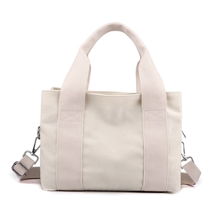 Women's canvas handbag in cream white with adjustable shoulder strap and dual handles
