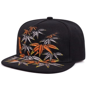 Black snapback hat featuring vibrant bamboo leaf embroidery and flat brim design