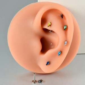 Detailed view of G23 titanium labret studs with colorful rhombus zircon inlay options