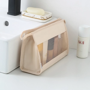Large capacity beige travel toiletry bag with mesh design and side handle for organization