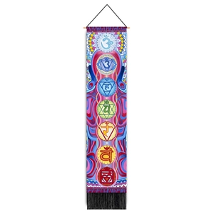 Detail of colorful chakra symbols and mandala patterns on a fabric wall hanging tapestry