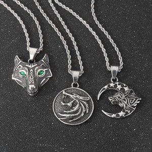 Viking wolf pendants in stainless steel with green eyes and moon star designs