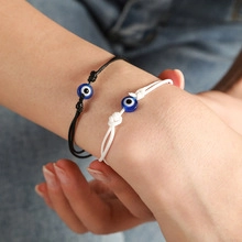 Detail of hand-woven Evil Eye bracelets in black and white with adjustable cord