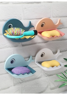 Detail showing wall-mounted whale-shaped soap dishes in blue, pink, and white tones