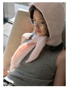 Detailed knit texture of a pink floral vintage balaclava hat with soft ties