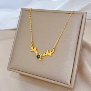 Minimalist gold titanium steel necklace with a reindeer antler pendant and black stone inlay