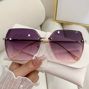 Detail of oversized rimless gradient lenses with stylish metal rivet accents and case