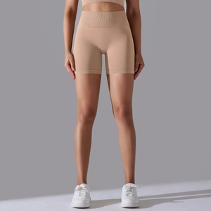 Detail of high-waist seamless sports shorts in beige with wide ribbed waistband for tummy control